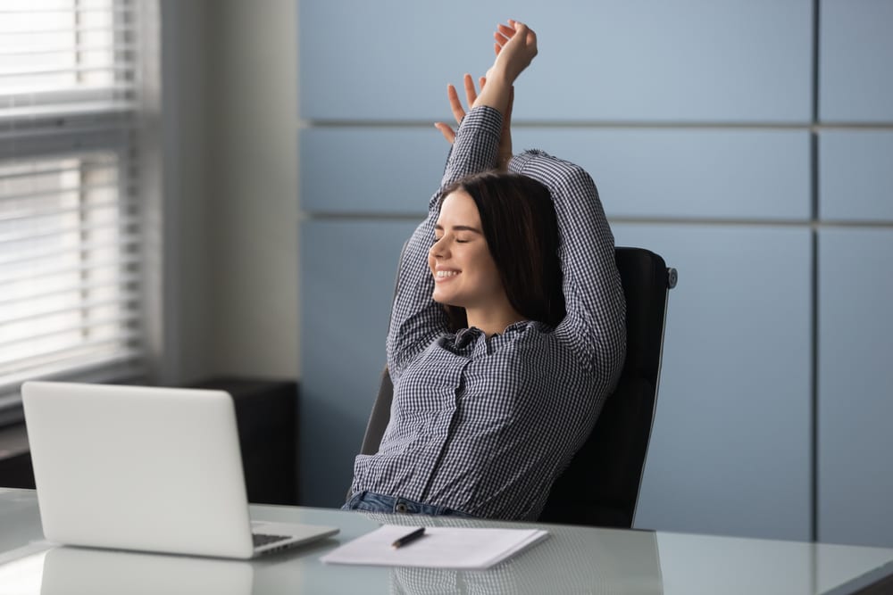 Business woman stretching at desk